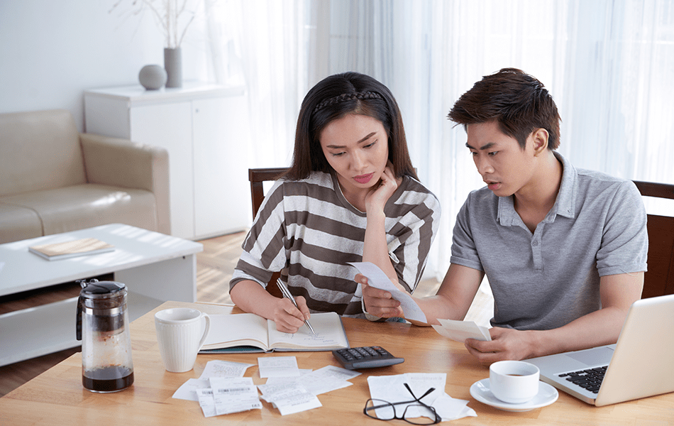 Asian couple checking expenses